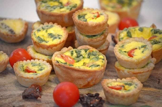 a close up of mini quiche.