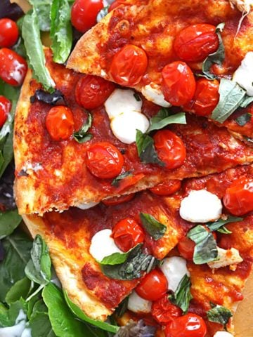A pizza with cherry tomatoes.