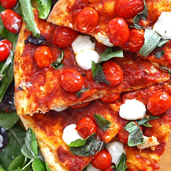 A pizza with cherry tomatoes.