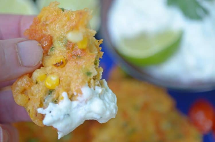 Dipping a cornfritter in a creamy sauce.