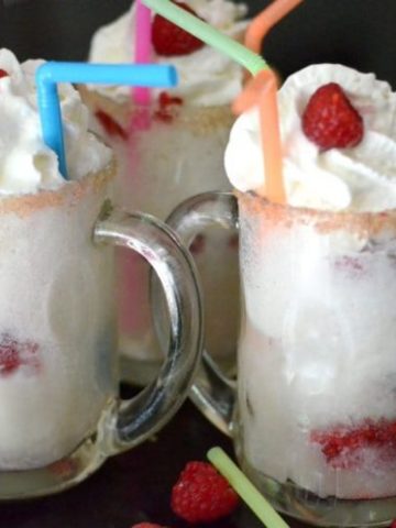 A close up of a glass of raspberry ice cream.