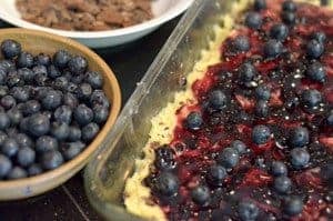 a tray of uncooked blueberry chocolate dessert bars.