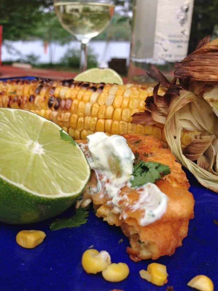 A plate of food on a table, with Corn fritters