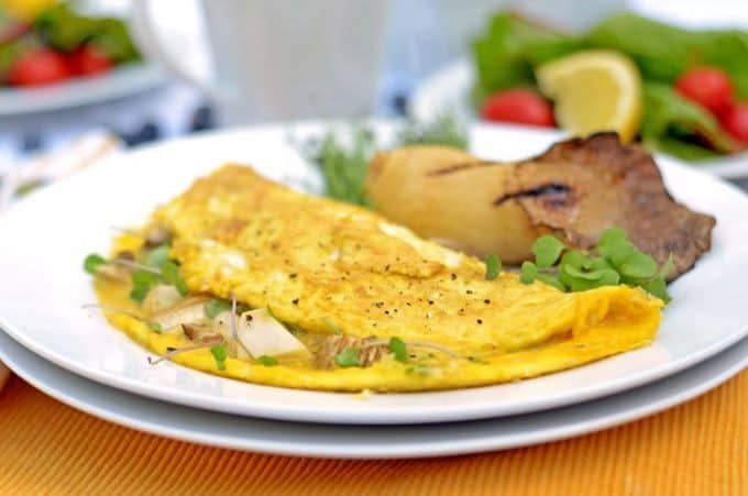 a mushroom omelet on a plate.