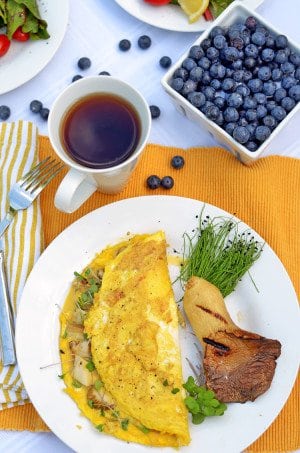 An omelet with a cup of coffee.