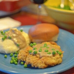 a plate of chicken-fried steak with gravy.