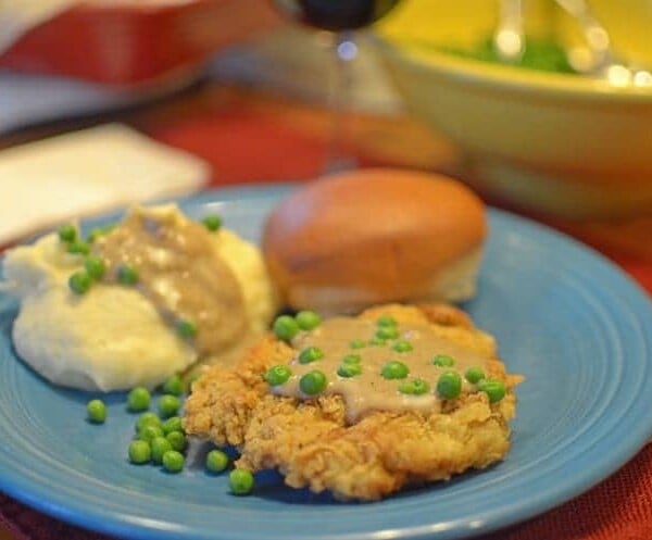 a plate of chicken-fried steak with gravy.