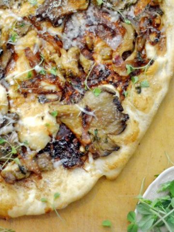A pizza sitting on top of a cutting board.