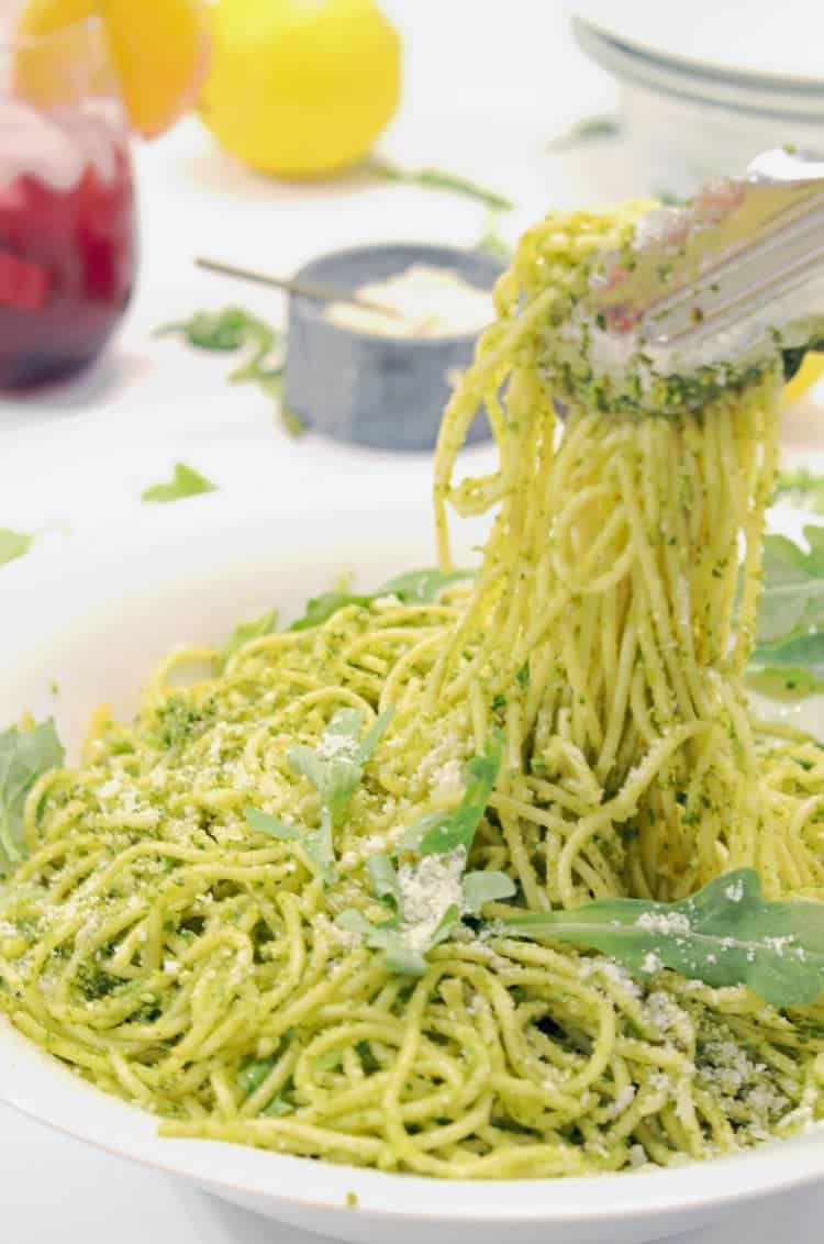 A bowl of pasta salad on a plate, with Pesto