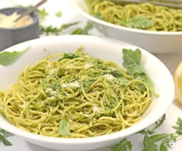 A bowl of pasta with pesto.