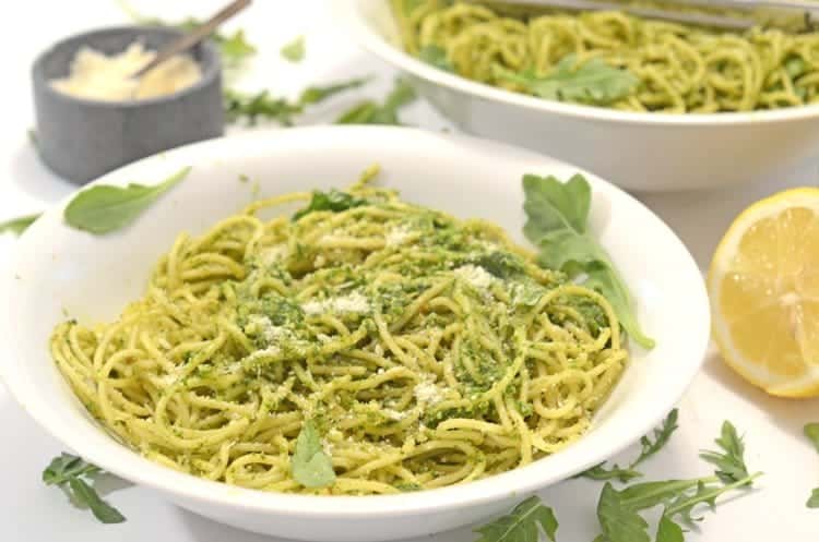 A bowl of pasta with pesto.