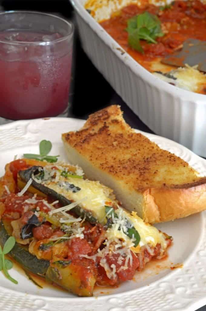 zucchini lasagna with garlic bread on a plate