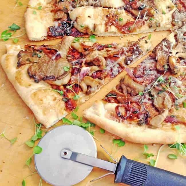 A pizza on a cutting board.