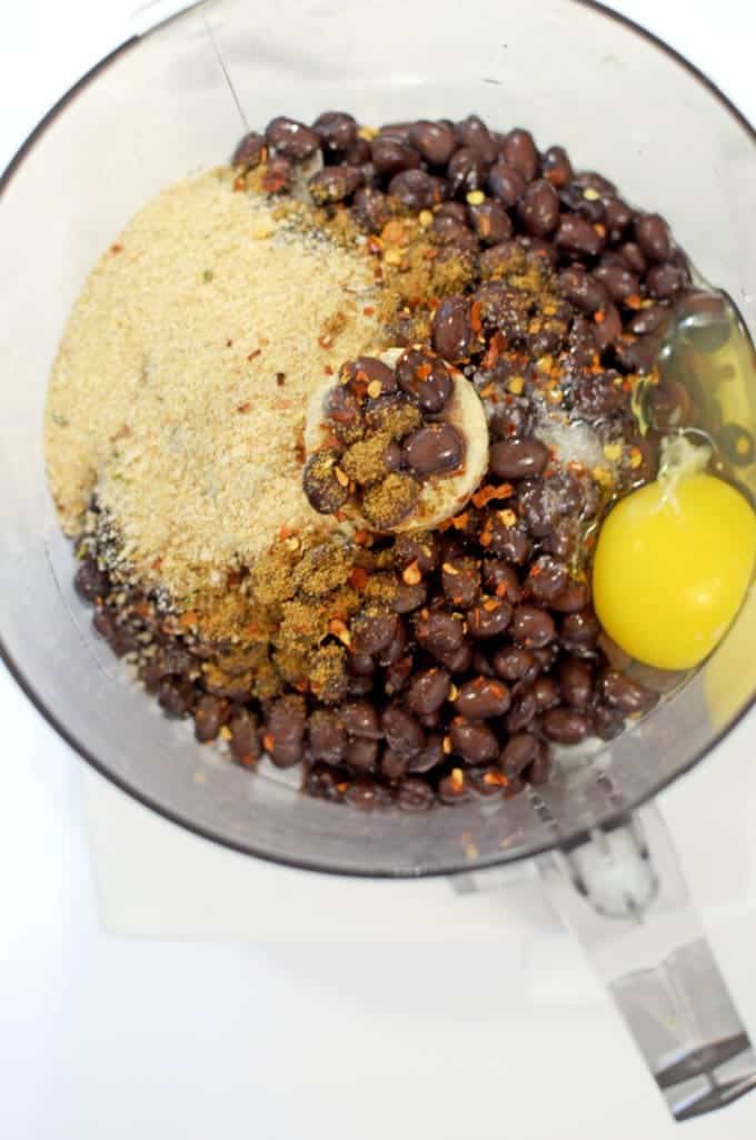 A bowl full of black beans, egg and breadcrumbs.