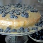 A blueberry cake on a stand.