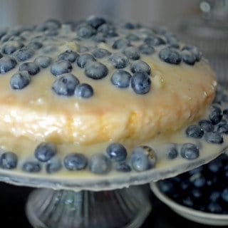 A blueberry cake on a stand.