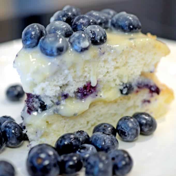 a slice of cake topped with blueberries