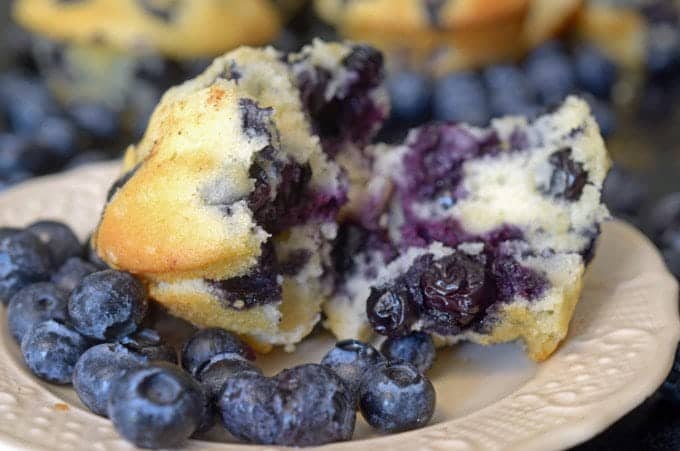 A close up of half a blueberry muffin.