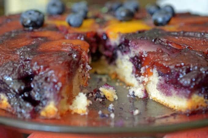 A slice of peach cake on a plate.