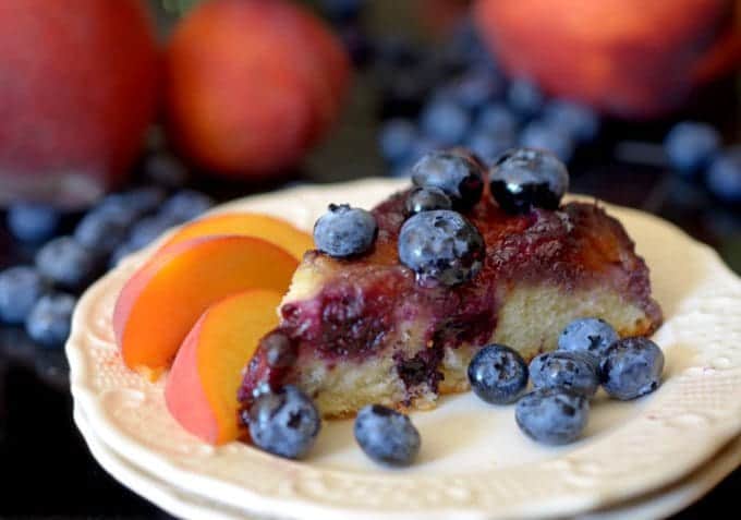 a slice of cake with blue berries