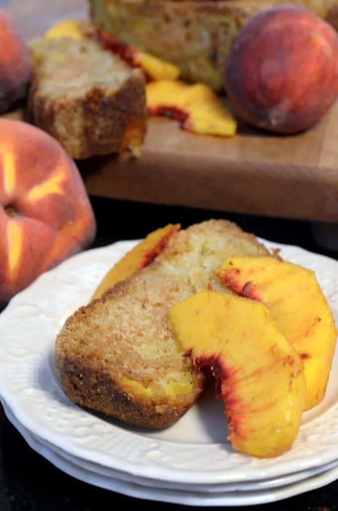 A slice of bread with peaches on a plate