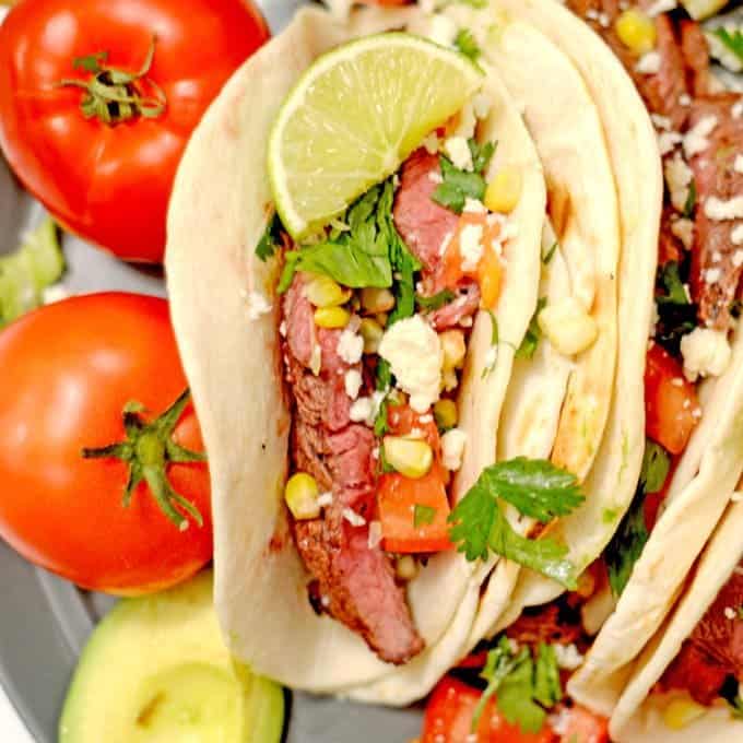 A steak taco on a plate.