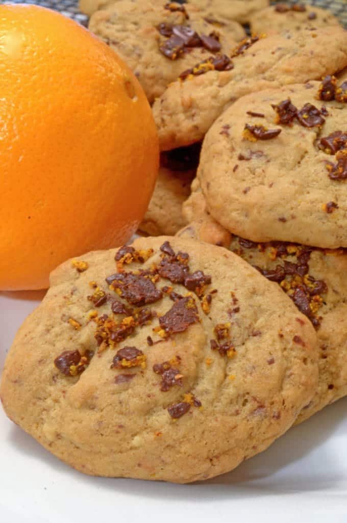 a bunch of cookies and an orange