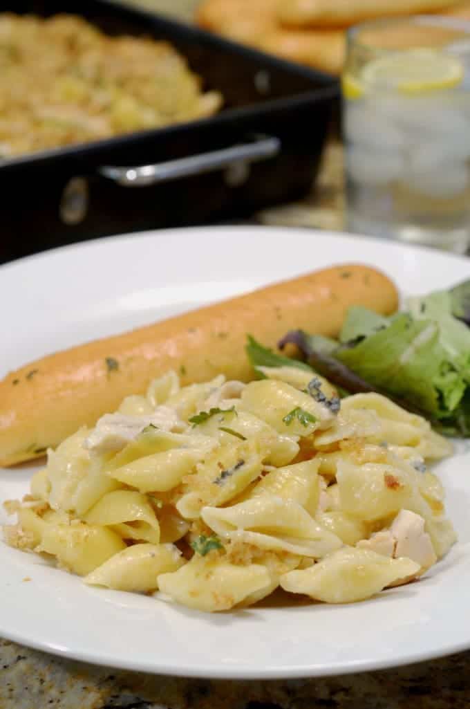 A plate of food on a table, with Chicken and Sauce