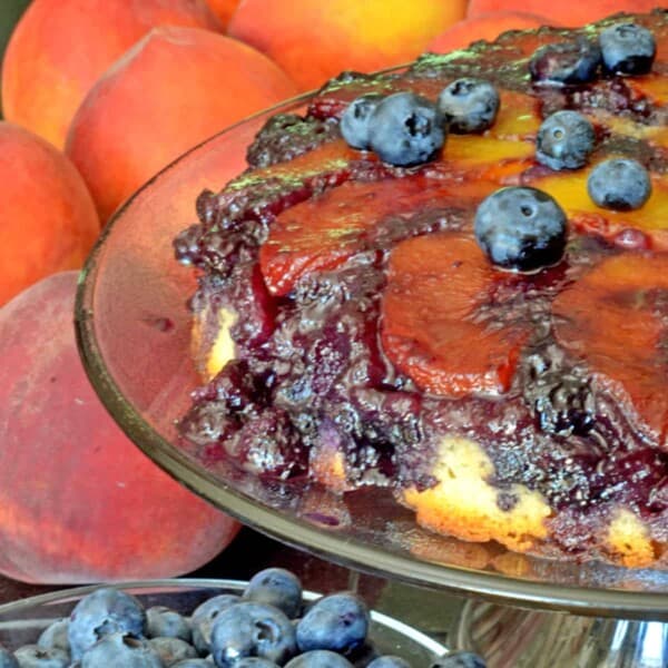 A peach cake with blueberries on top.