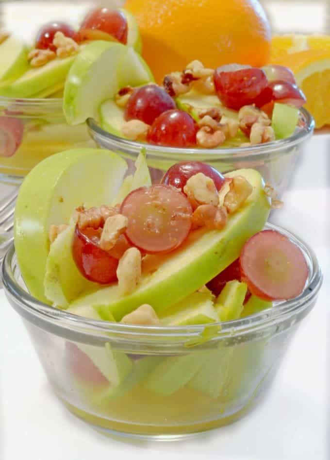 a couple of bowls of apple and grape salad