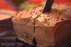 A blueberry cake with chocolate icing.