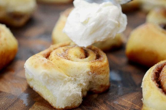 icing rolling onto a cinnamon roll