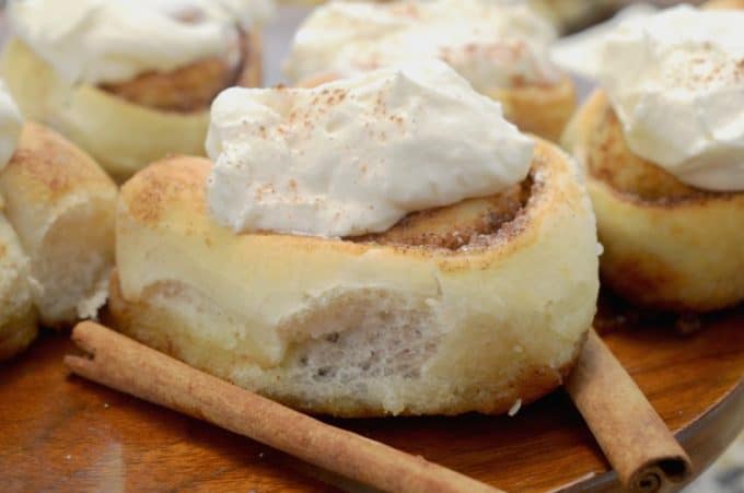 a cutting board of cinnamon rolls