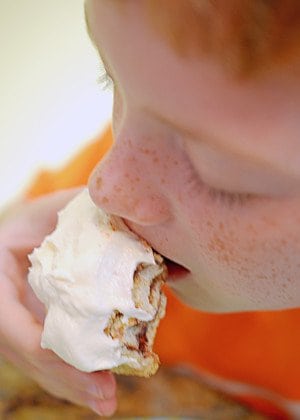 boy eating a cinnamon roll