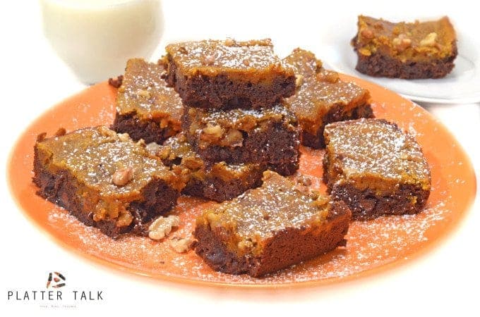 Pumpkin brownies stacked on a plate.