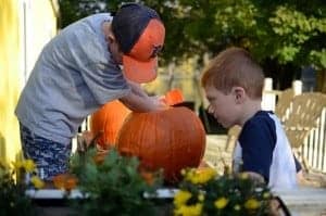 boys picking a pumpkin
