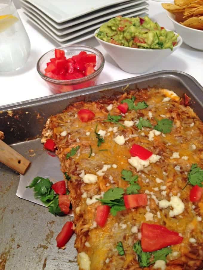 A dish is filled with food, with Enchilada and Chicken