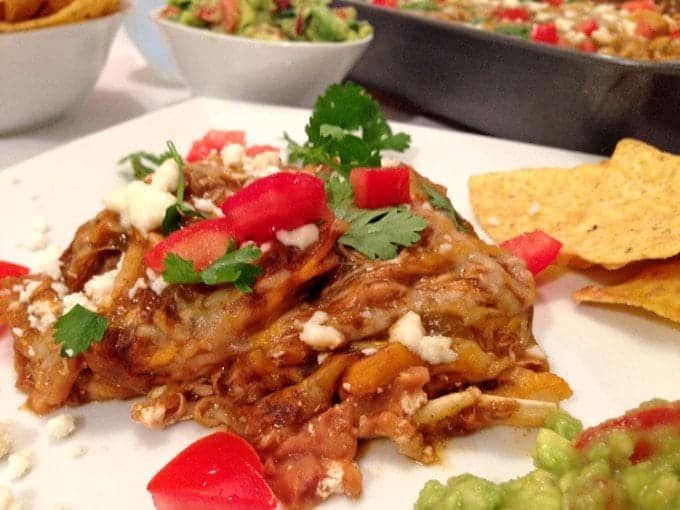 A plate of food, with Enchilada and Chicken