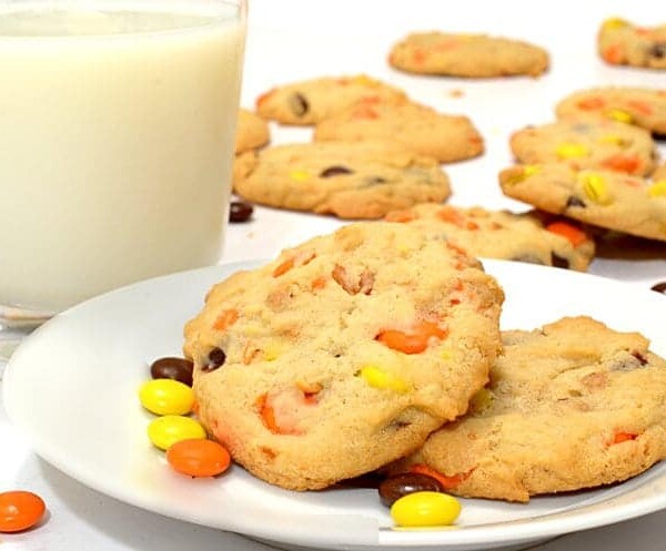 A plate of peanut butter cookies with a glass of milk.