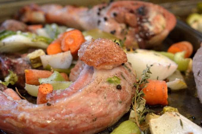 A tray of turkey parts being roasted on an oven rack