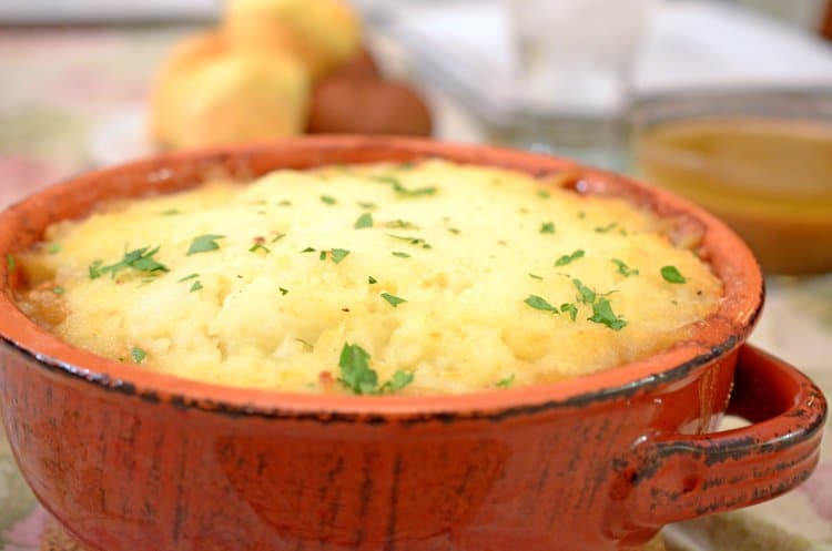 A bowl of food, with Shepherd\'s pie and Potato