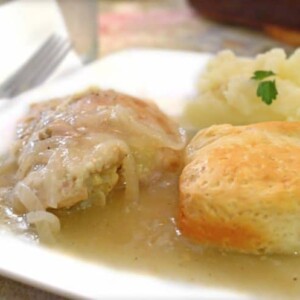 A plate of food with biscuits and gravy