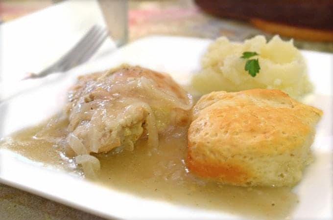 A plate of food with biscuits and gravy