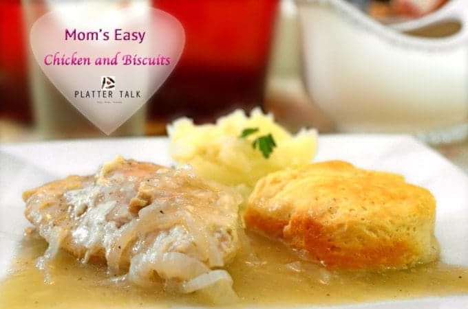 A biscuit with chicken and gravy on a plate