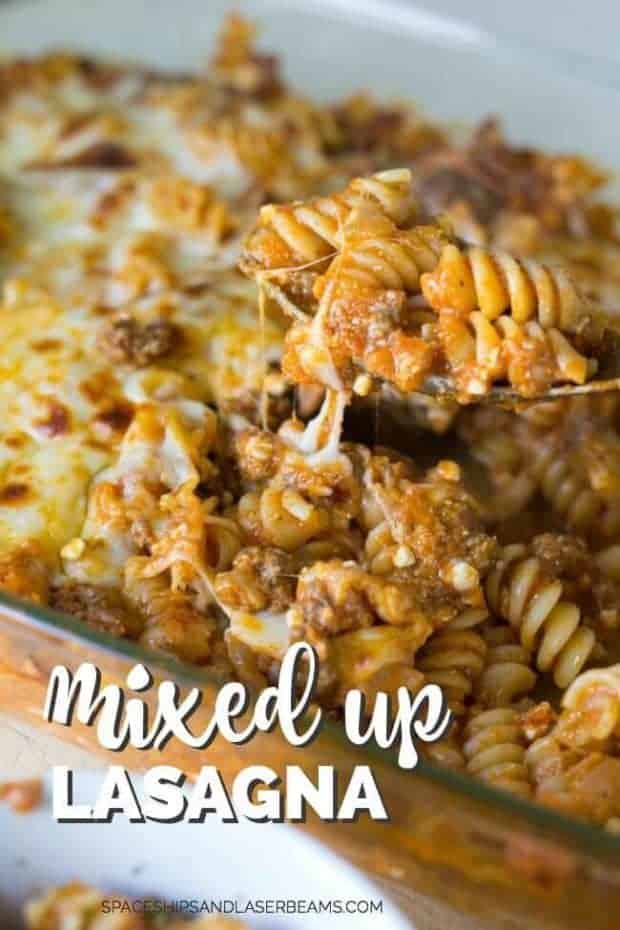 A spoon lifting baked pasta with meat, red sauce and cheese fro dish