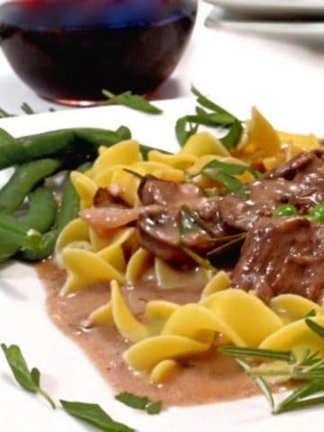 A plate of beef tips with noodles