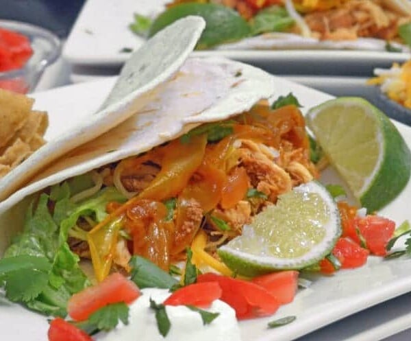 A plate of food with lime and fajita