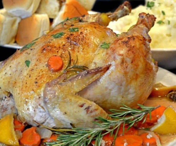 A roast chicken covered in herbs
