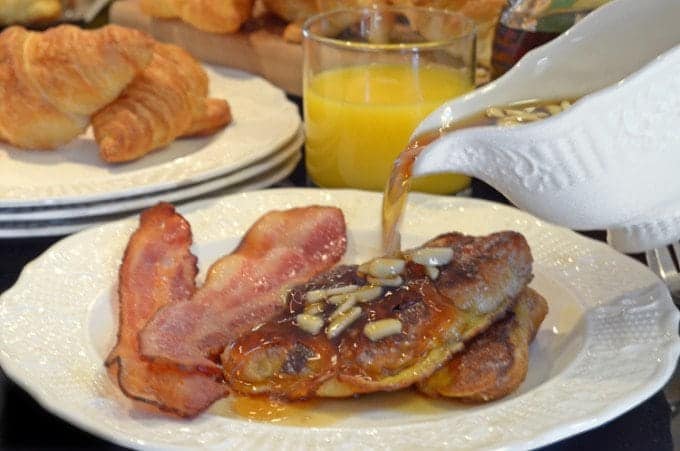 a plate of french toast with bacon