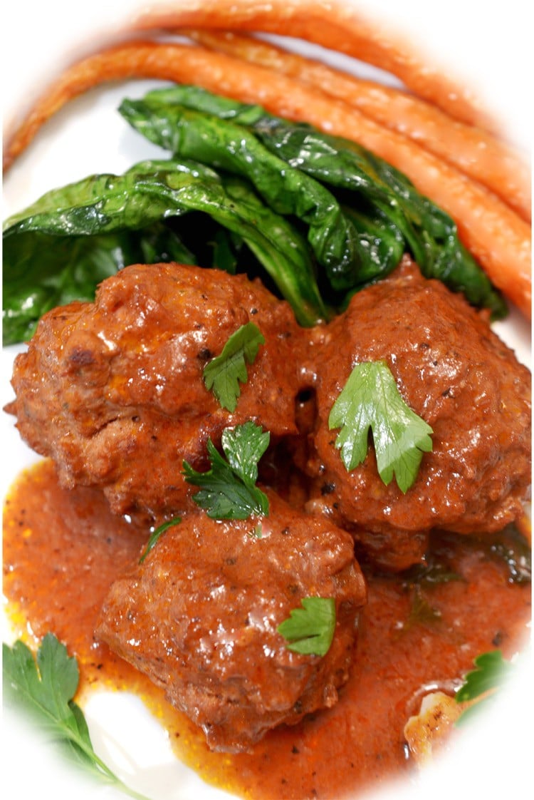 plateof meatballs surrounded by carrots.